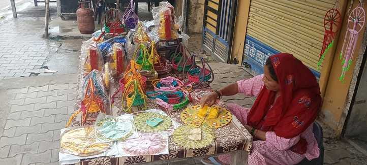 Satya Devi of Dabkhedi is making clothes, swings and cradles for Kanha ji