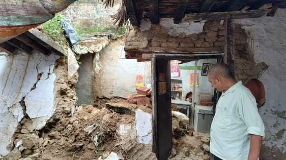 The house collapsed in the sun after the rain