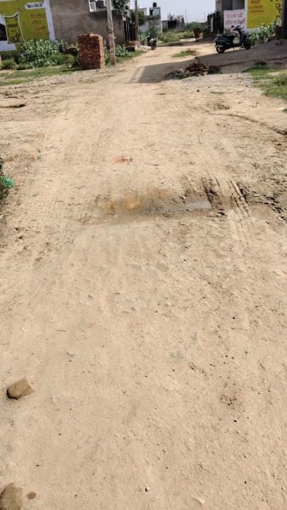 Slippery unpaved streets and monkeys guarding the roofs, living on Dhana Road has become difficult