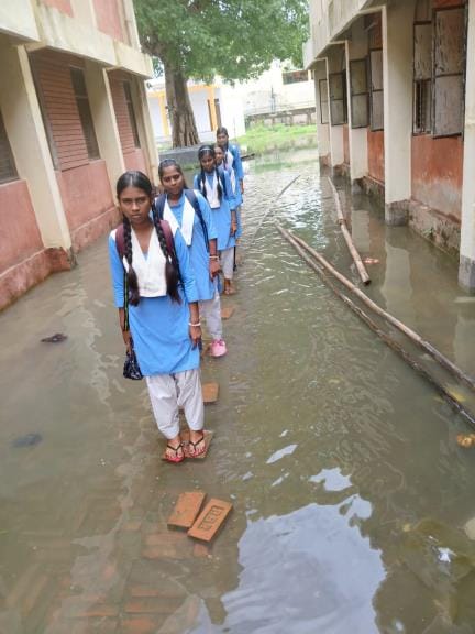 Girls go to study through dirty water