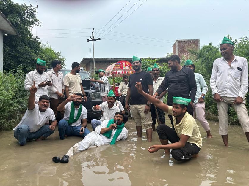Farmers protested by sitting in the water filled on the road