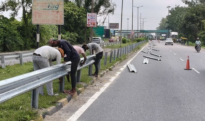 Work to repair broken grill underway on highway, vehicles crawled past