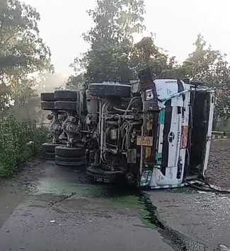 The truck overturned after hitting the wall of the bridge