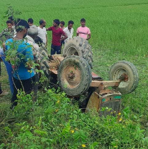 A farmer died after being crushed when a tractor overturned in a ditch