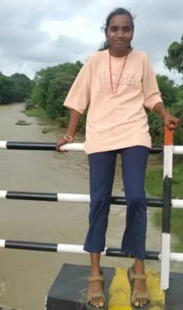A young girl sitting on railing of a culvert and getting her photo clicked fell into river and got swept away