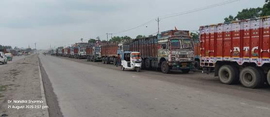 Trucks loaded with coal are standing on the road, causing traffic jam