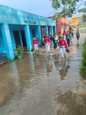 Rain water filled in the school, children studied in the open