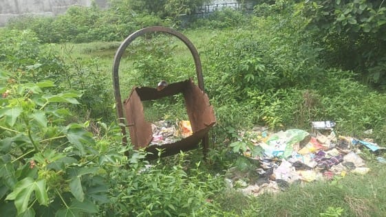 Dustbins missing, garbage in empty plots