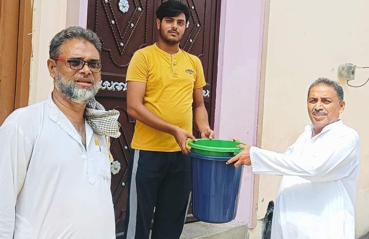 The chairman distributed dustbins door to door