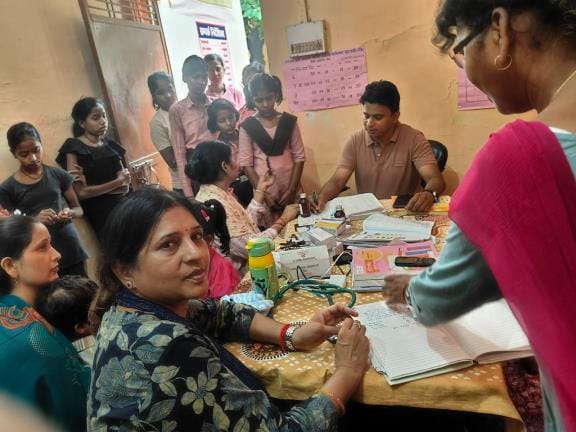 Health team conducting health checkup of girl students at Kasturba Vidyalaya Khalilabad