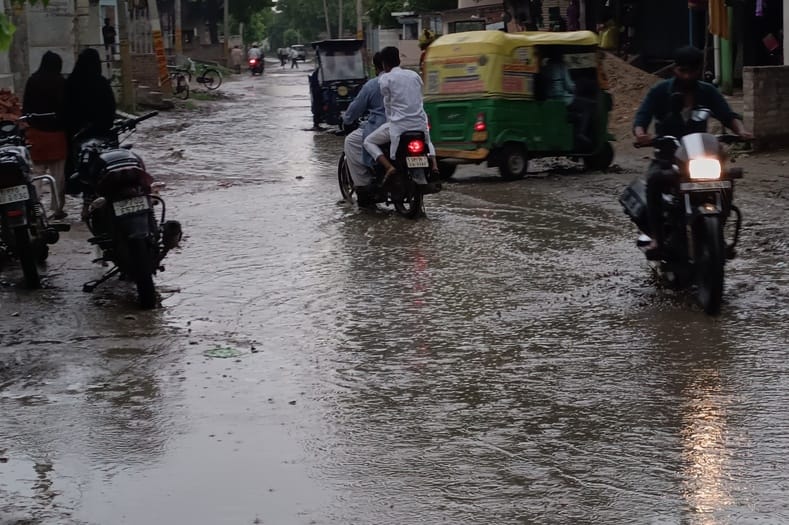 Waterlogging in the potholes on the roads, making walking difficult