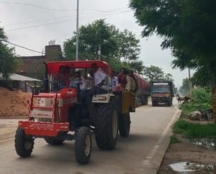 Passengers being carried in tractor trolley