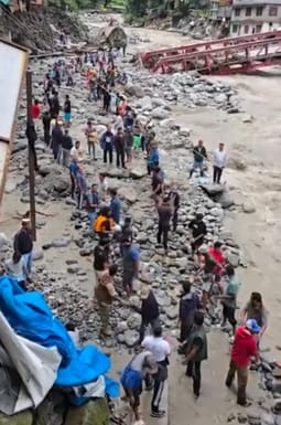 The bridge is broken but not the courage... the villagers are busy building the road themselves