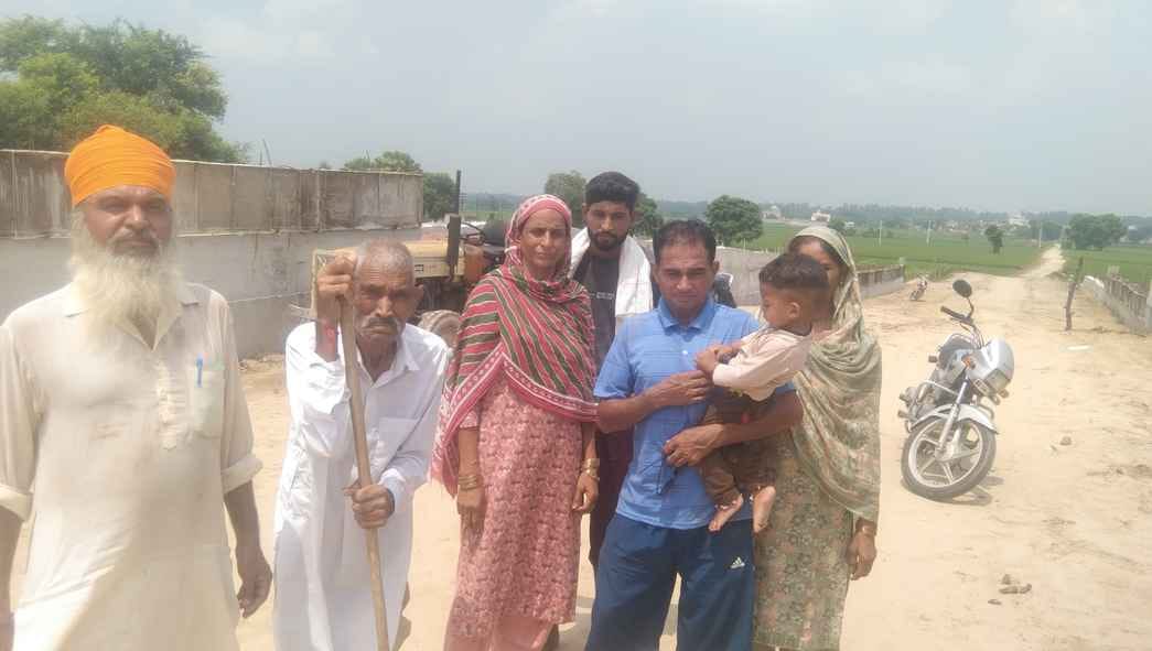 Farmer family picketing under-construction bridge