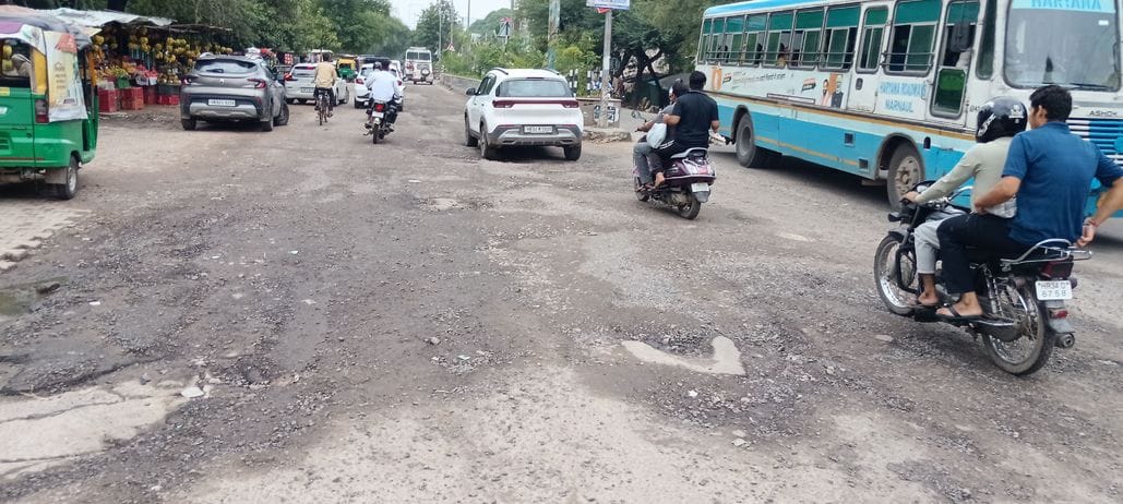 Model road in bad condition due to rain, deep potholes formed at many places