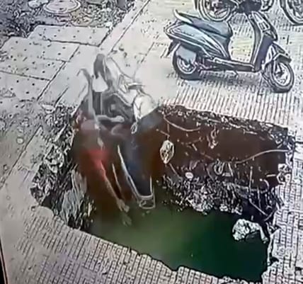 A disabled person fell into a 12 feet deep open drain along with his scooter, narrowly escaped death