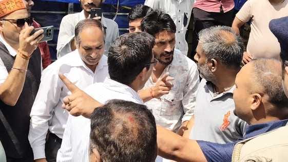 An unknown person sitting in ADM's car with beacon, advocates got angry