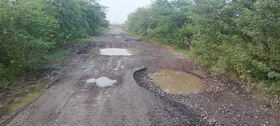 People are passing through the nine kilometer road which has been covered with potholes for two years
