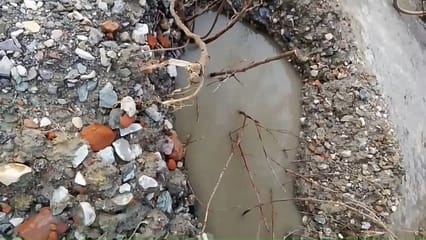 Pipeline burst, water filled in potholes on the road