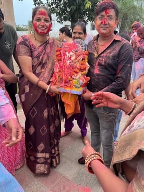 Devotees went out to immerse the idol throwing gulal