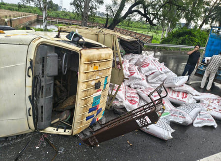 A mini truck loaded with poultry feed went out of control and overturned on the highway