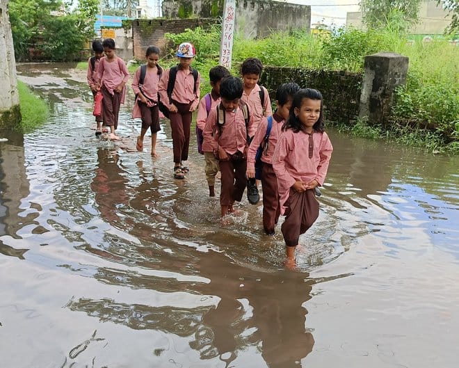 Students reaching school through waterlogging