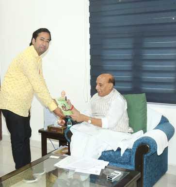 poet amar gifted his book to defence minister Rajnath singh