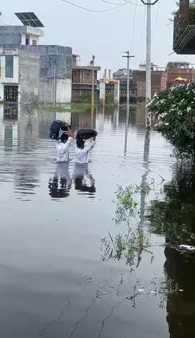 Waterlogging up to three feet in three colonies adjacent to the city, children waded through chest-deep water
