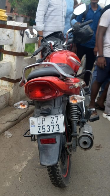 The old man parked his bike on the bridge, wrote his wife's phone number on the petrol tank and jumped into the river