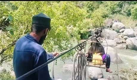 Villagers crossing the river with the help of wire and trolley
