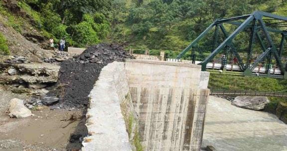 The pit is being filled to connect the road to the bridge, vehicles will be able to reach the villages