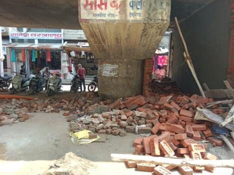 Bulldozer ran on the shop being built under the overbridge