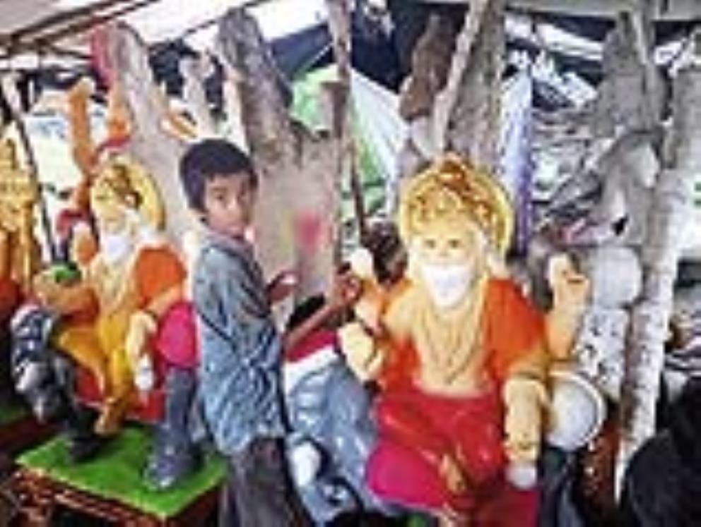 Market decorated for Vishwakarma Jayanti, artists preparing idols