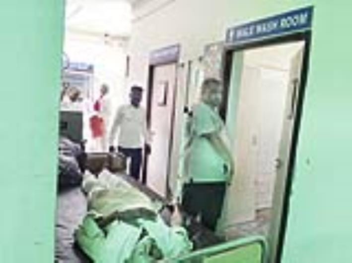 Current state of the civil hospital: Health relies on the toilet facilities, patients seen on beds in front of the foul-smelling toilet door.
