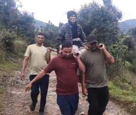 Villagers carried the sick elderly man on a doli (palanquin) three kilometers to the main road.