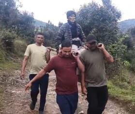 Villagers carried the sick elderly man on a doli (palanquin) three kilometers to the main road.