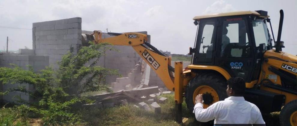 The boundary wall and construction of an illegal colony built on government land were demolished.