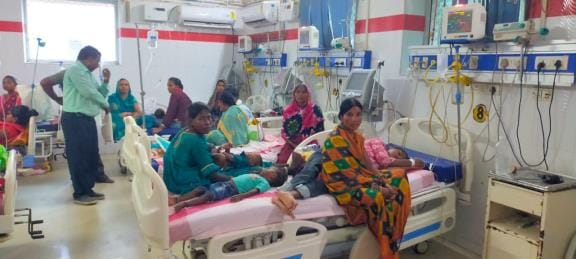 Medical College: Children's ward full, two children treated on one bed.