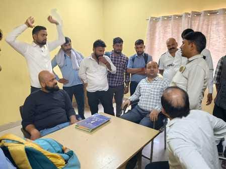 Labor union officials surrounded the manager and depot in-charge.