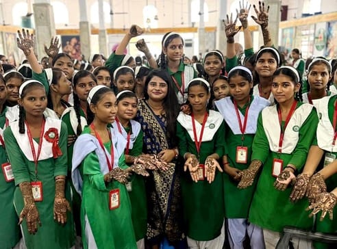 Girls gathered at the temple, their palms decorated with henna.