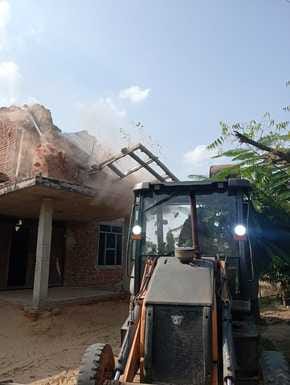 Bulldozer runs on illegal construction