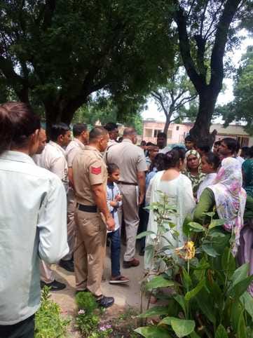 Women surrounded the school for indecent behavior towards girls.