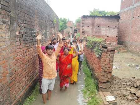Villagers protest by standing in waterlogging