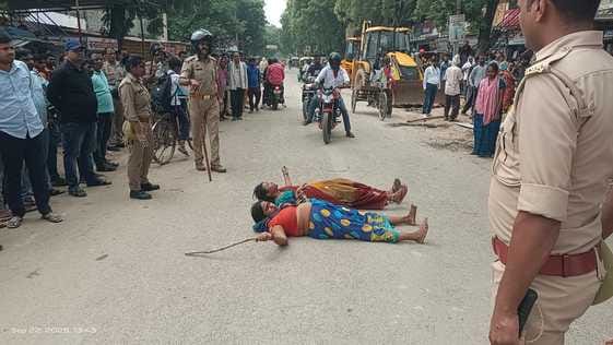 Women lay down on the road in protest against encroachment removal and attempted self-immolation.