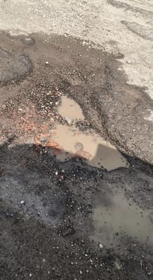 Potholes on the Shahabad-Bilari road make travel difficult.
