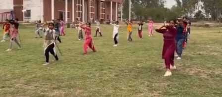 Suchitra is teaching her daughters the skill of using a stick.