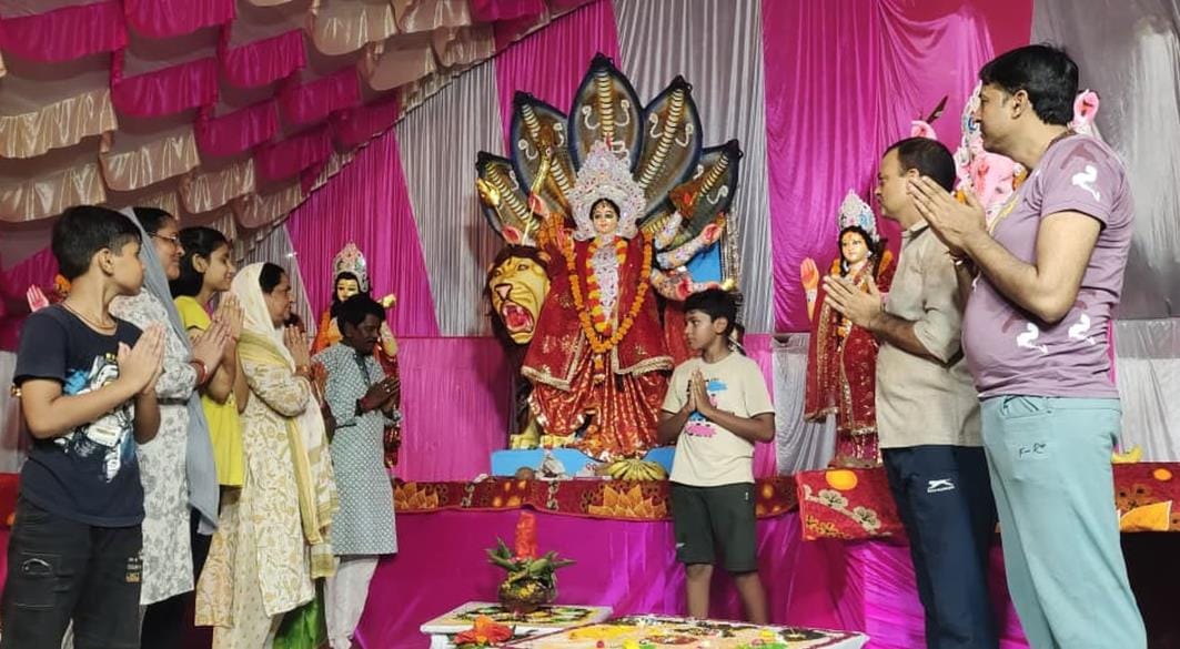 Devotees bowing their heads in puja pandals