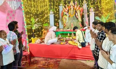 Devotees immersed in the worship of Goddess Durga