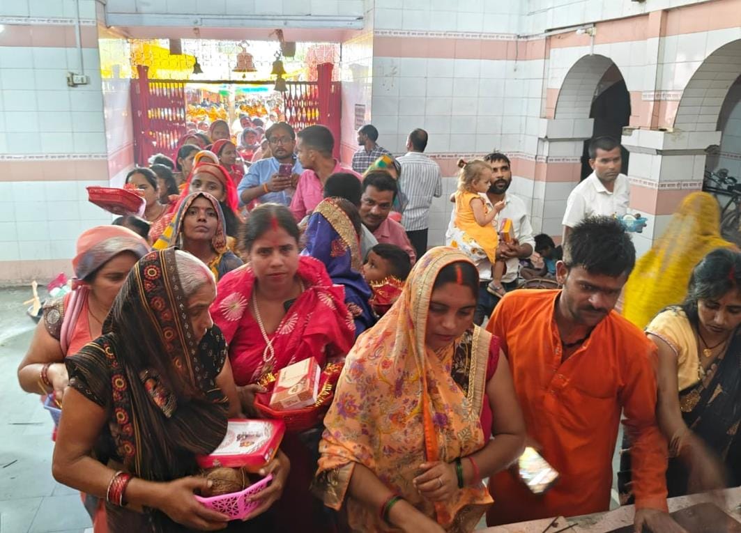 Devotees bowed their heads in the court of the Mother