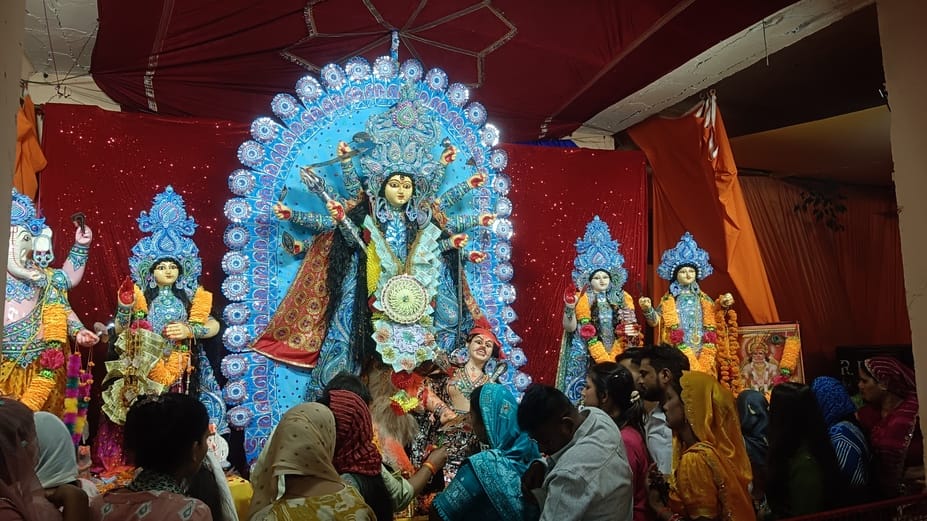 The doors of the idols opened, the pandal echoed with cheers.